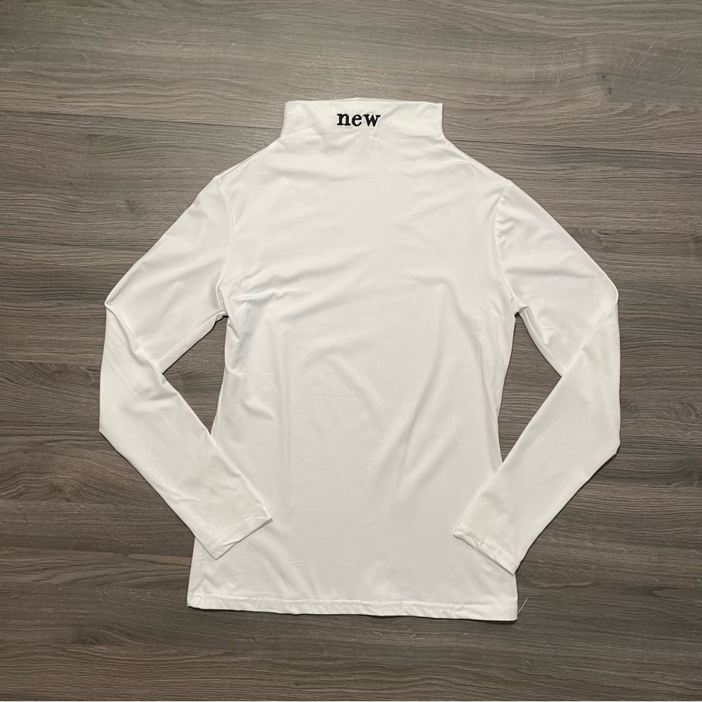 White mock neck long sleeved top